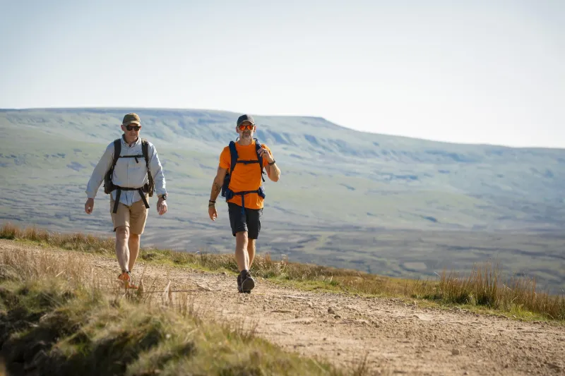 Walkers on the rounded Howgills above Sedbergh during a guided walking festival