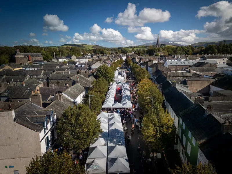Crowds browsing food and drink stalls at Taste Cumbria Cockermouth in the town centre
