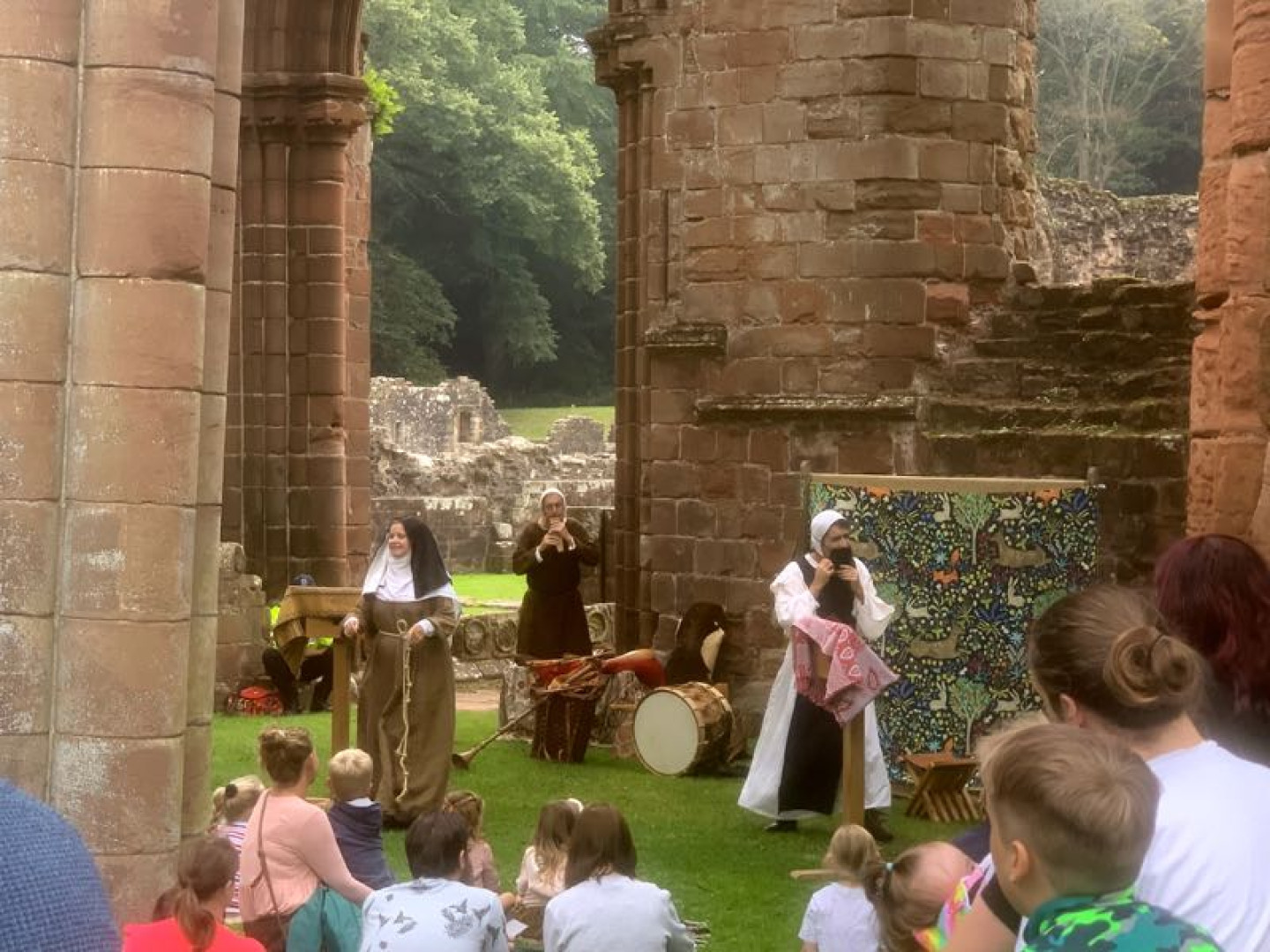 Medieval re-enactors among the red sandstone ruins of Furness Abbey